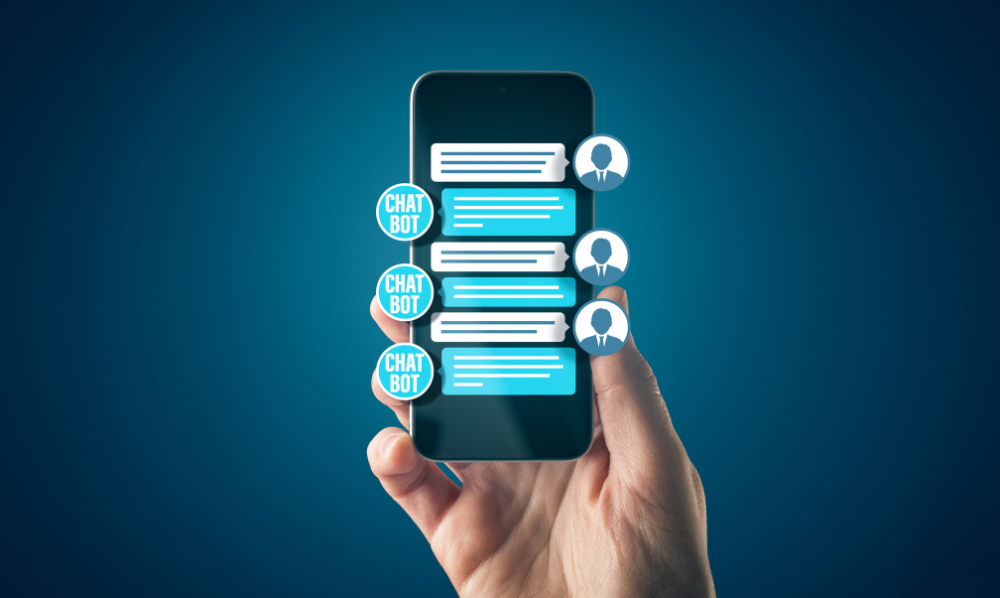 A hand holds up a mobile phone with a text message thread with a chat bot illuminated.